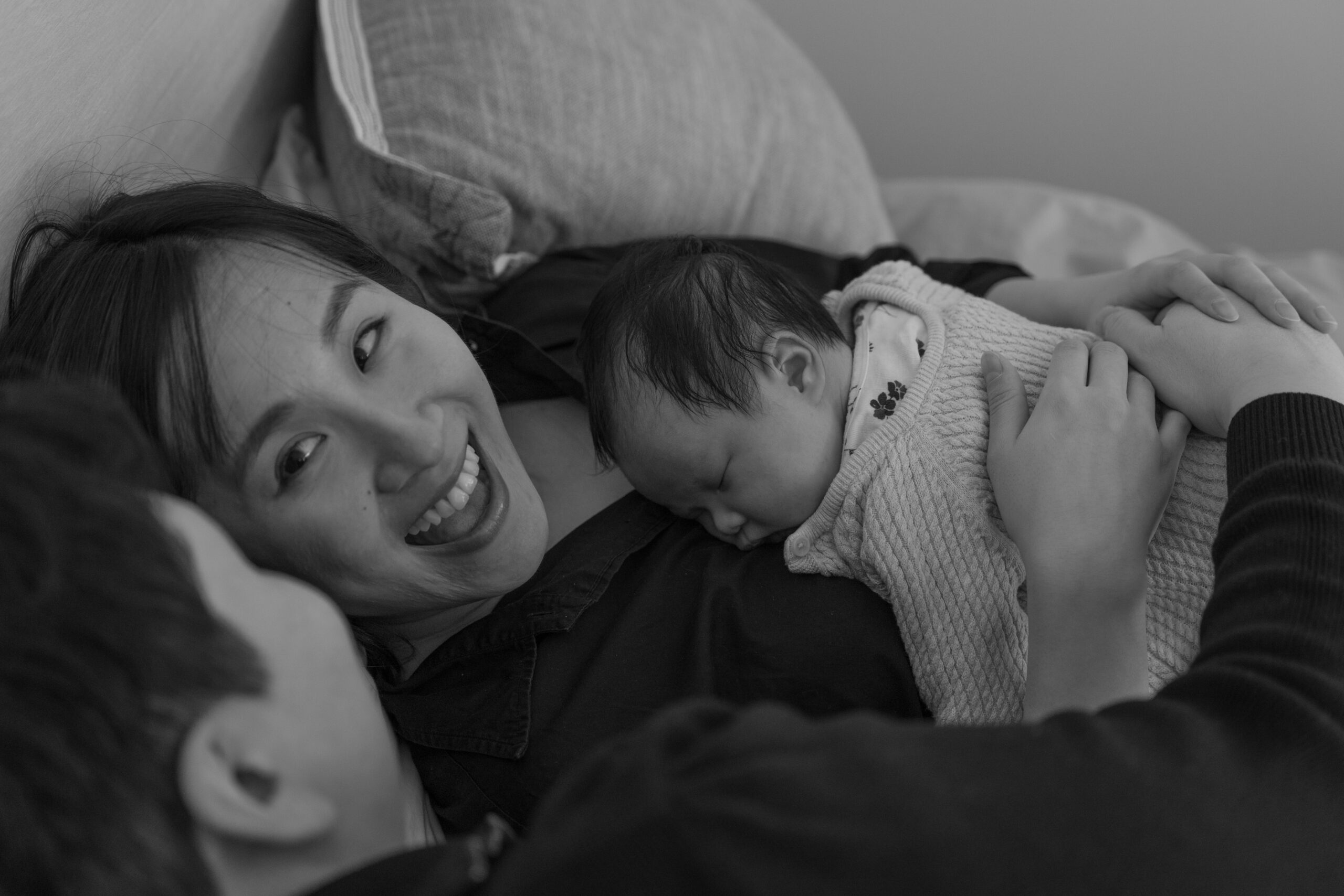 Mom and dad having a quiet moment while baby sleeps on mom